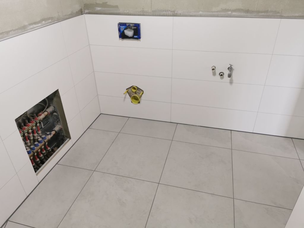 Ansicht der Toiletten und Waschtisch Wand, Fliesen Verlegung mit weissen Steingut Wandfliesen,